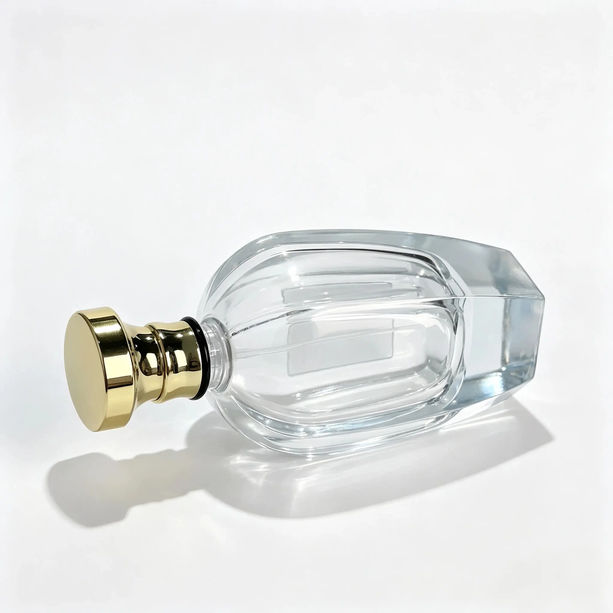 100ml Ribbed Glass Perfume Bottle - Side Profile Side-laid view of 100ml ribbed clear glass perfume bottle showing the thick base and vertical grooves