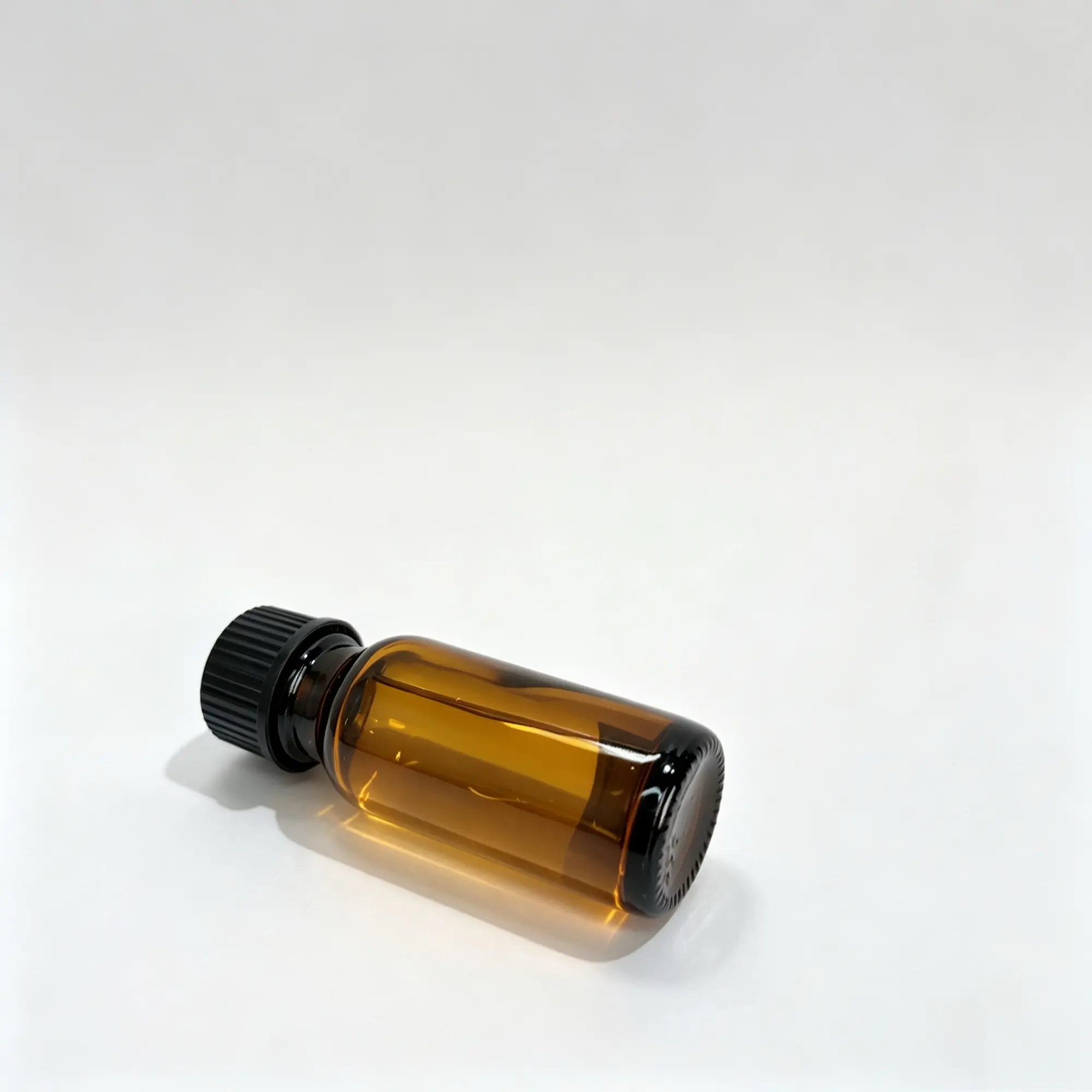 15ml Euro Dropper Essential Oil Bottle Side View 15ml Euro dropper essential oil bottle lying on its side with the black screw cap attached