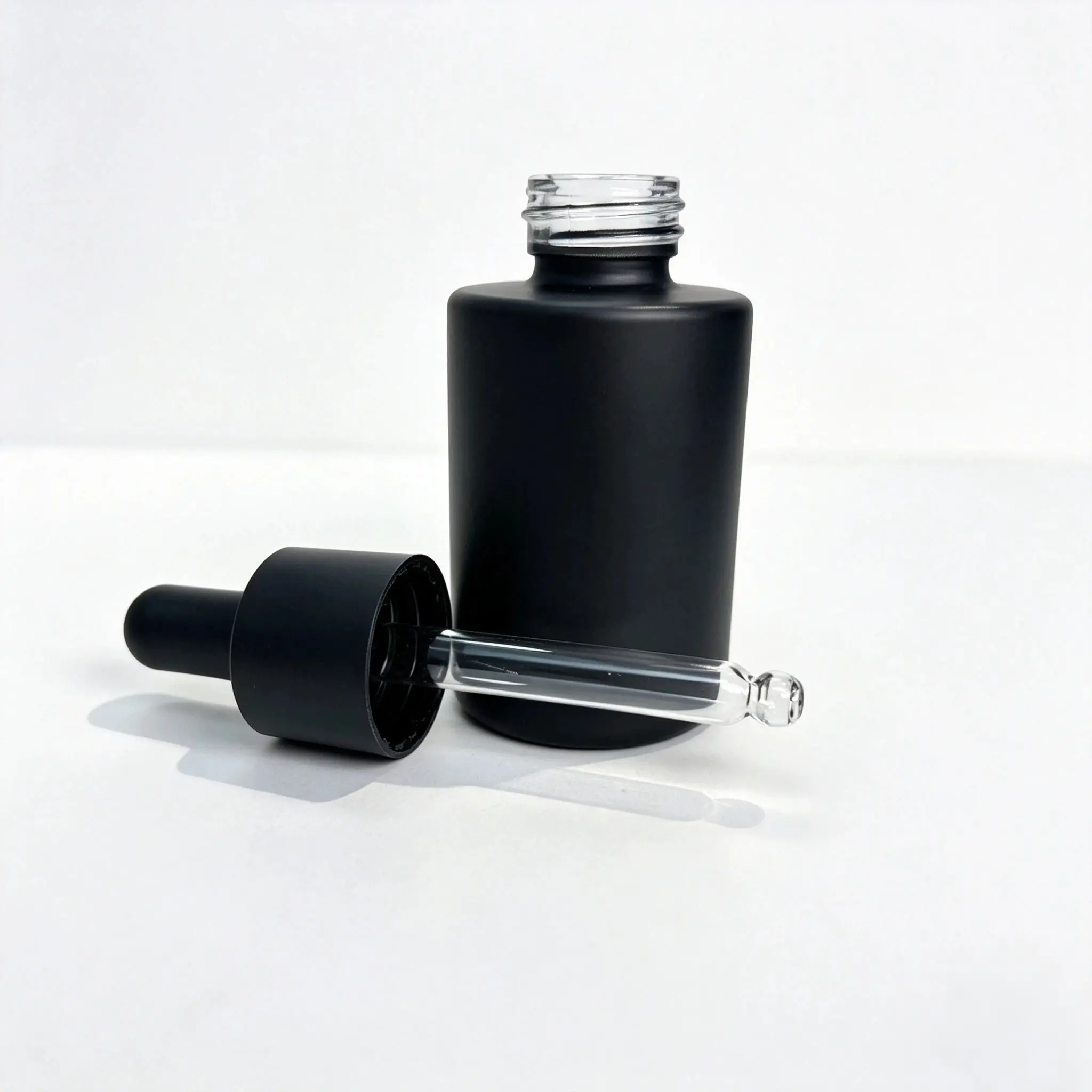 30ml Essential Oil Dropper Bottle Component Set Matte black 30ml essential oil dropper bottle displayed with its separate dropper cap and bottle components
