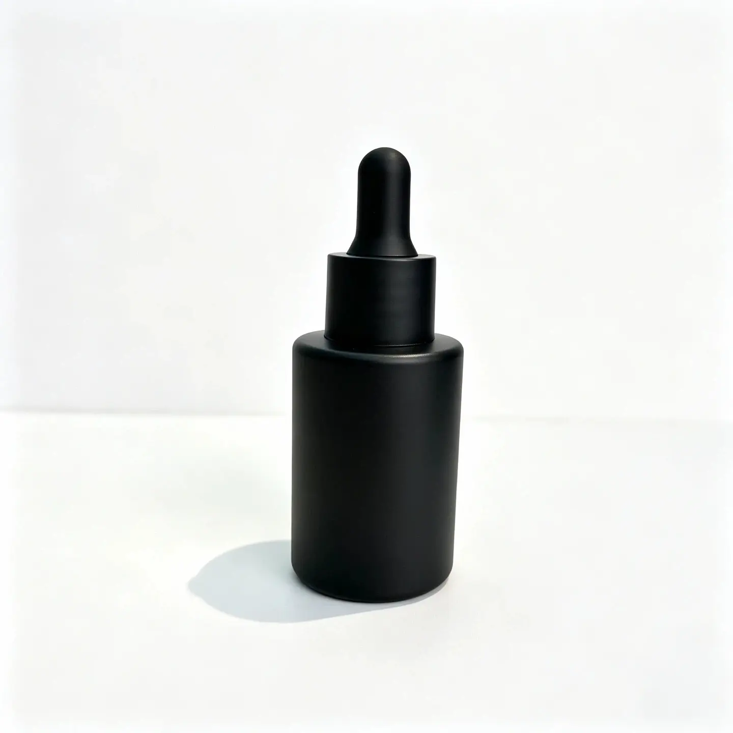 30ml Matte Black Essential Oil Dropper Bottle Front View Matte black 30ml essential oil dropper bottle with a cylindrical body and matching black dropper on a white background