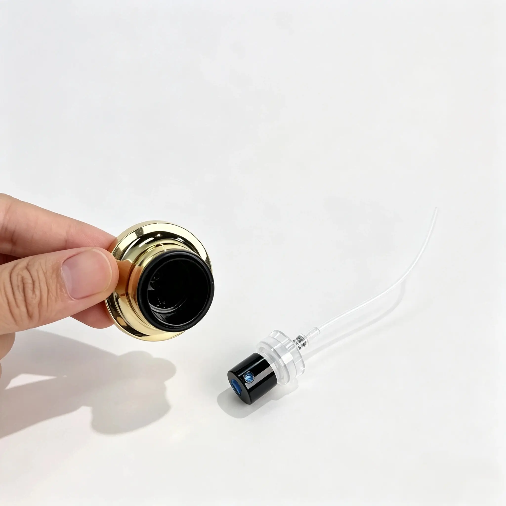 Perfume Bottle Cap Underside and Spray Pump Detail Underside of gold perfume bottle cap and matching spray pump detail
